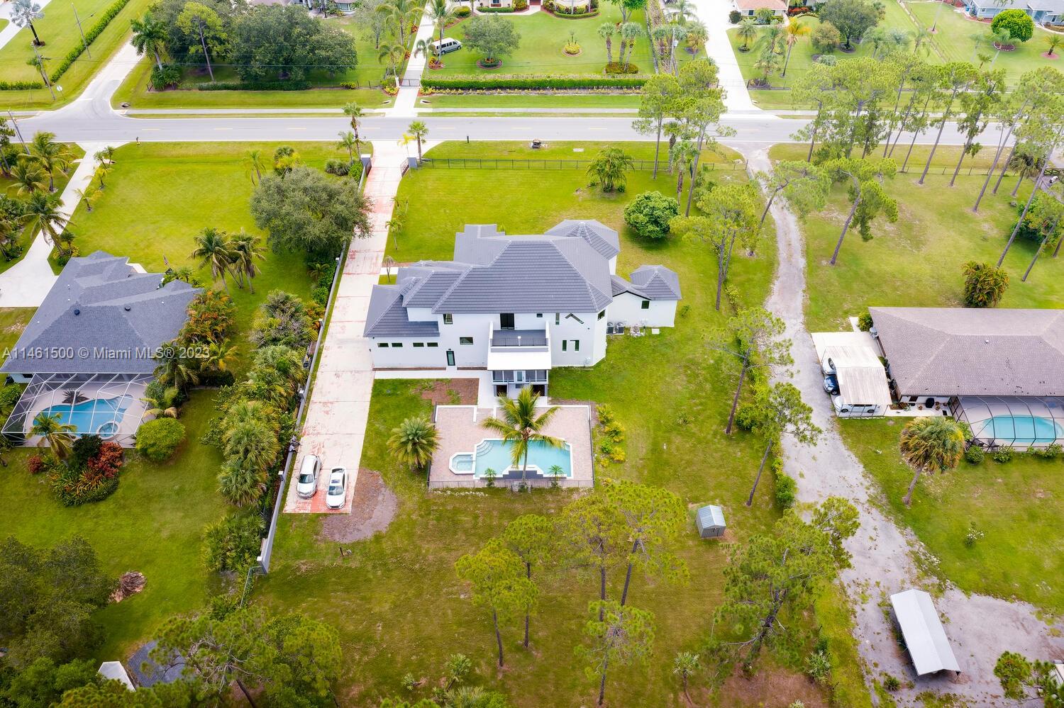 16189 Alexander Run Jupiter, FL 33478 - Photo 70 of 78 an aerial view of residential houses with outdoor space and swimming pool