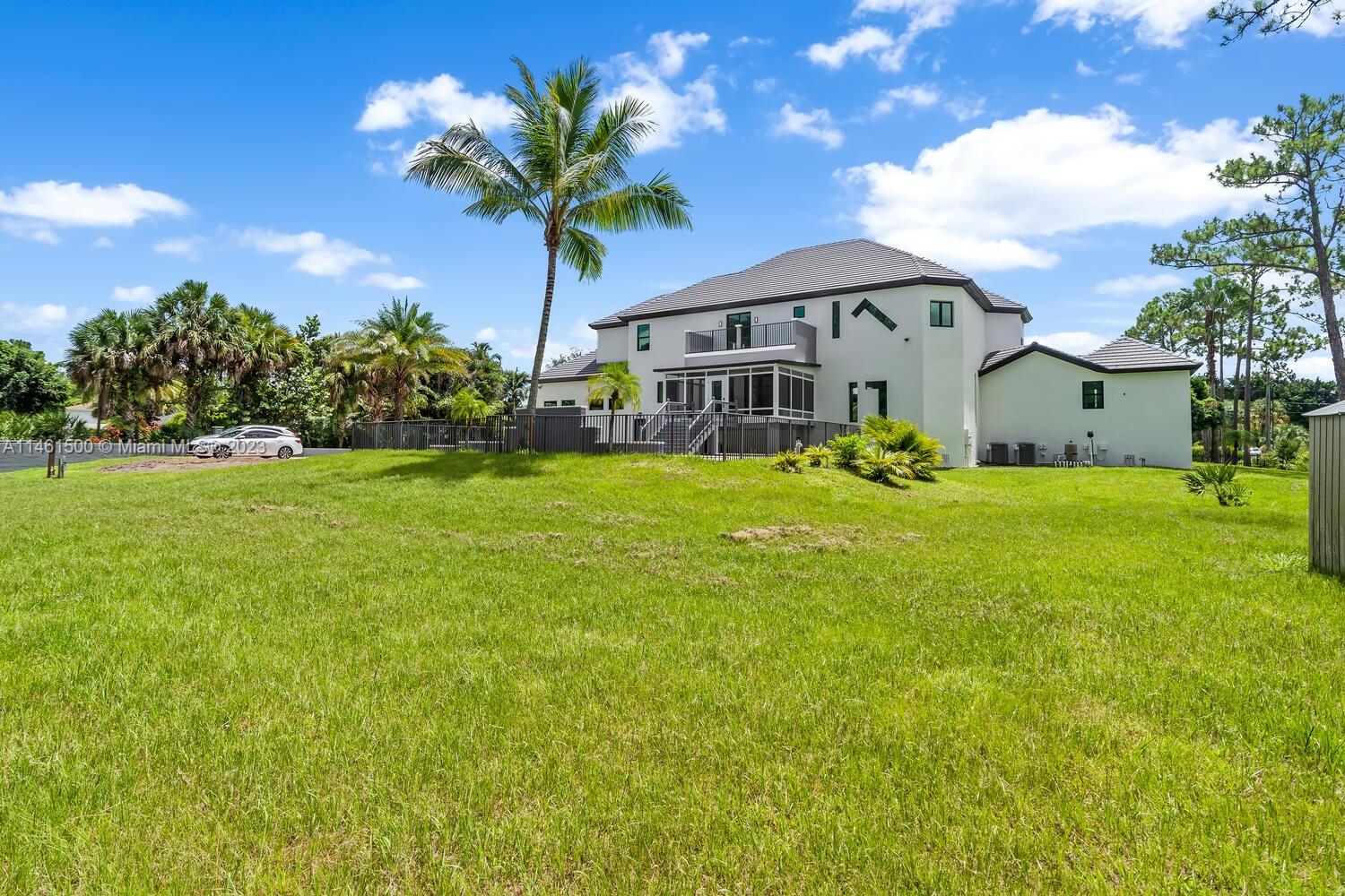 16189 Alexander Run Jupiter, FL 33478 - Photo 8 of 78 a front view of a house with garden