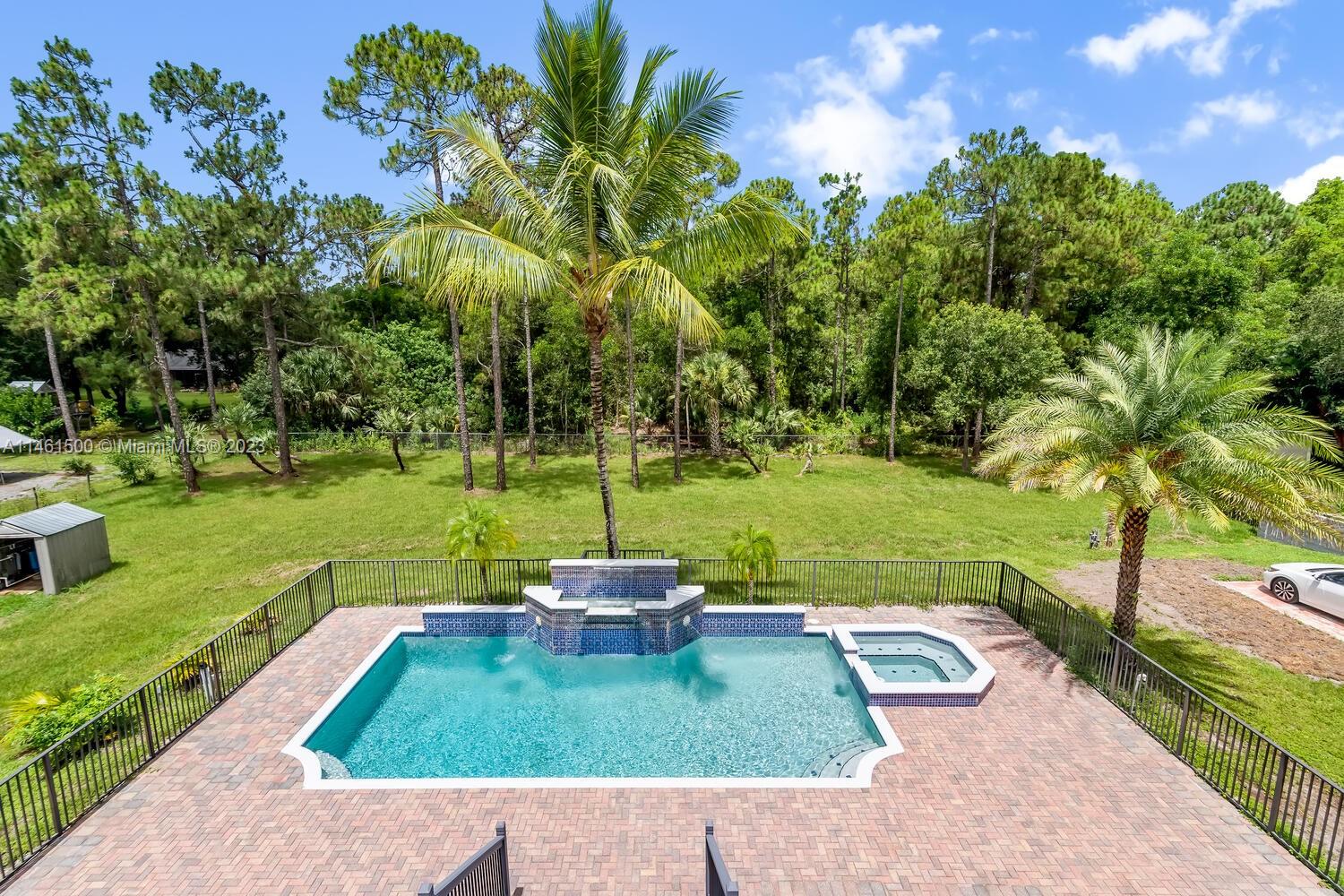 16189 Alexander Run Jupiter, FL 33478 - Photo 9 of 78 a view of a backyard with a garden