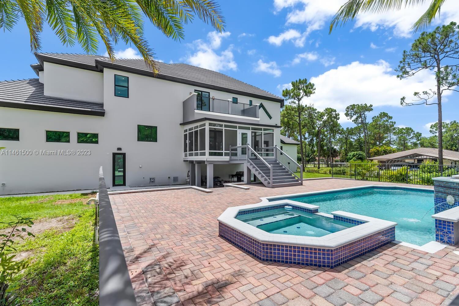 16189 Alexander Run Jupiter, FL 33478 - Photo 10 of 78 a front view of a house with a yard