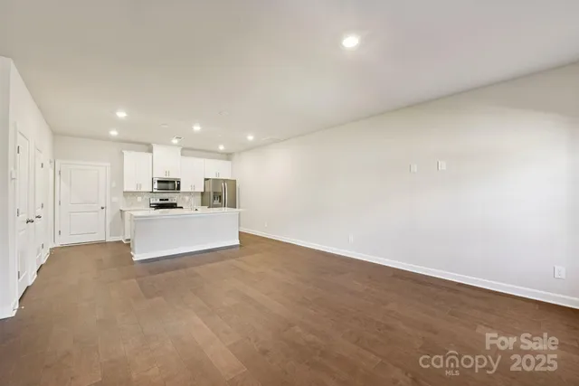 a view of kitchen with kitchen island sink and center island