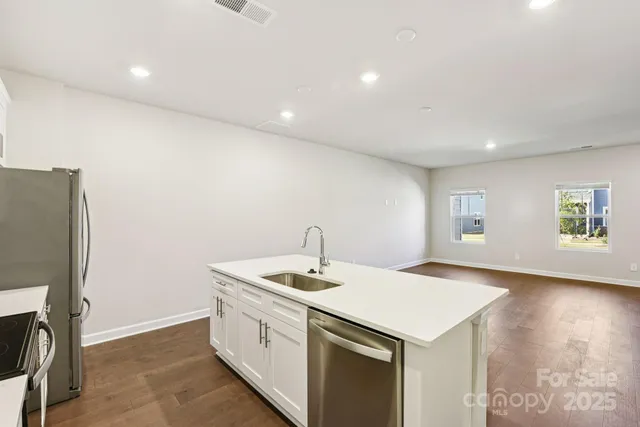 a utility room with wooden floor washer and dryer