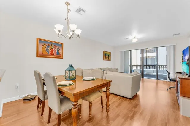 a view of a dining room with furniture wooden floor and a chandelier