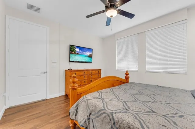 a bedroom with a bed and a flat screen tv
