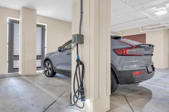 a view of a lobby with a chandelier and glass door