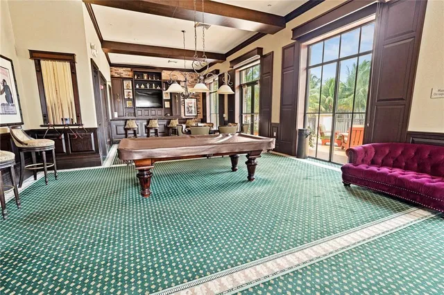 a white house with a yard plants and palm trees