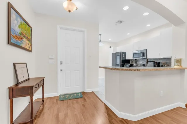a view of kitchen with cabinets and wooden floor