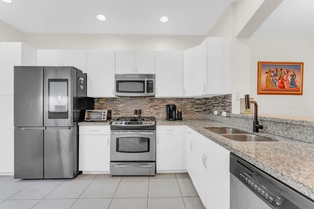 a kitchen with a sink a refrigerator and a sink