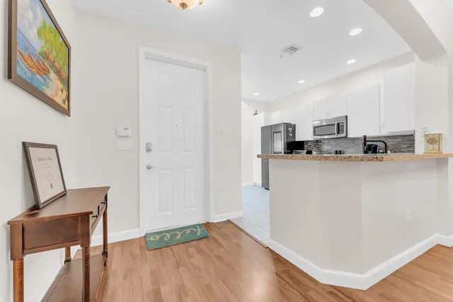 a kitchen with stainless steel appliances granite countertop a refrigerator sink and microwave