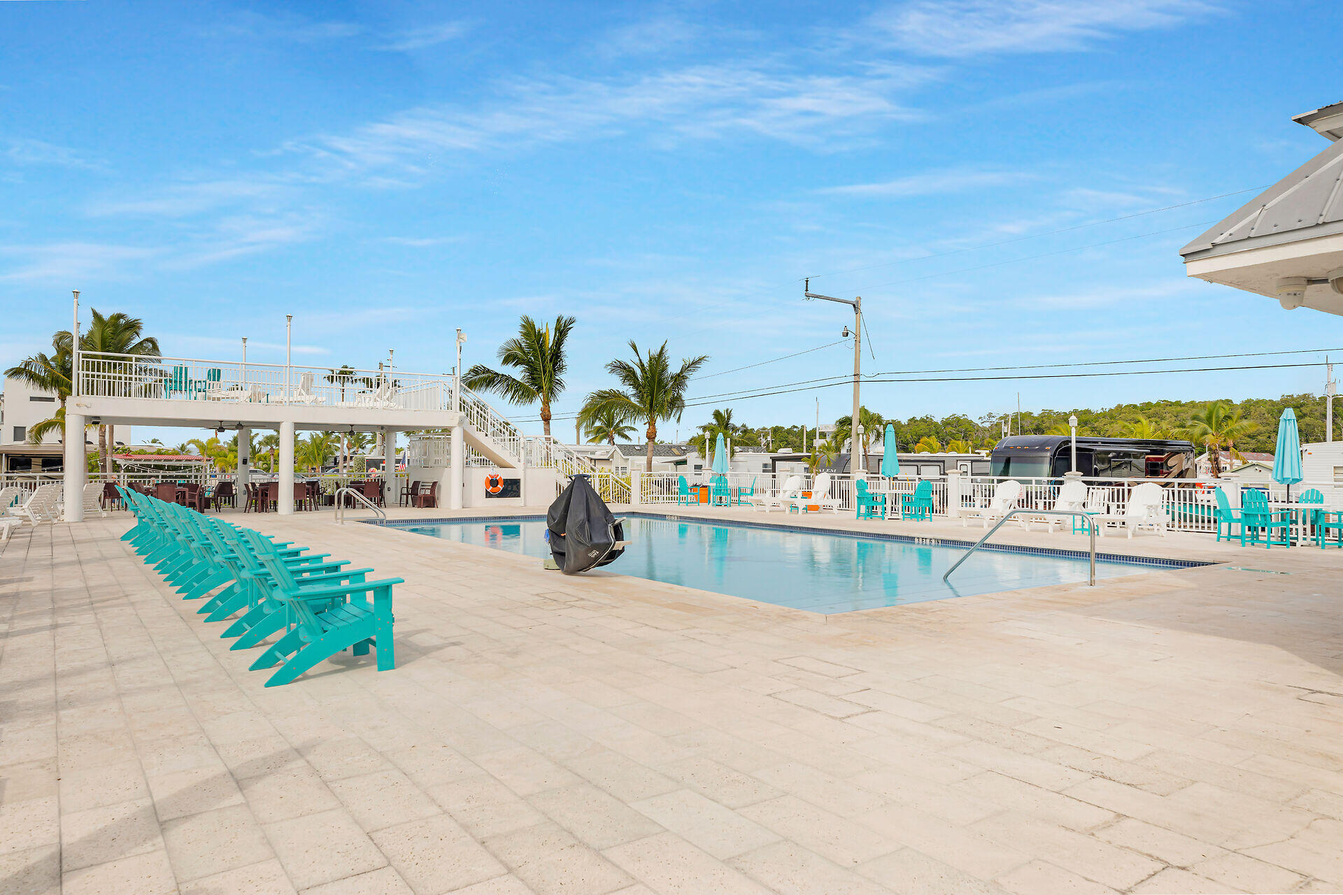 325 Calusa Street, Unit 250 Key Largo, FL 33037 - Photo 19 of 63 a view of a swimming pool and a lawn chairs