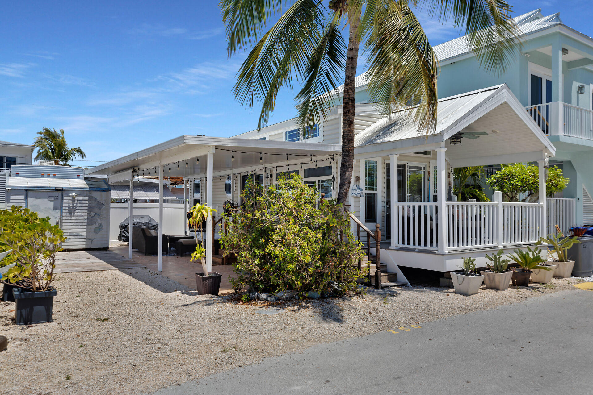 325 Calusa Street, Unit 250 Key Largo, FL 33037 - Photo 37 of 63 a front view of a house with a garden