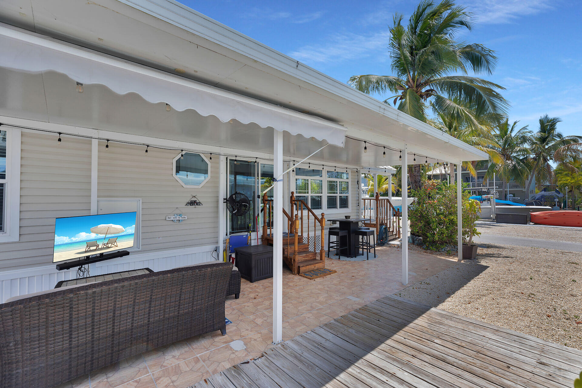 325 Calusa Street, Unit 250 Key Largo, FL 33037 - Photo 39 of 63 a view of a patio with table and chairs potted plants with wooden floor