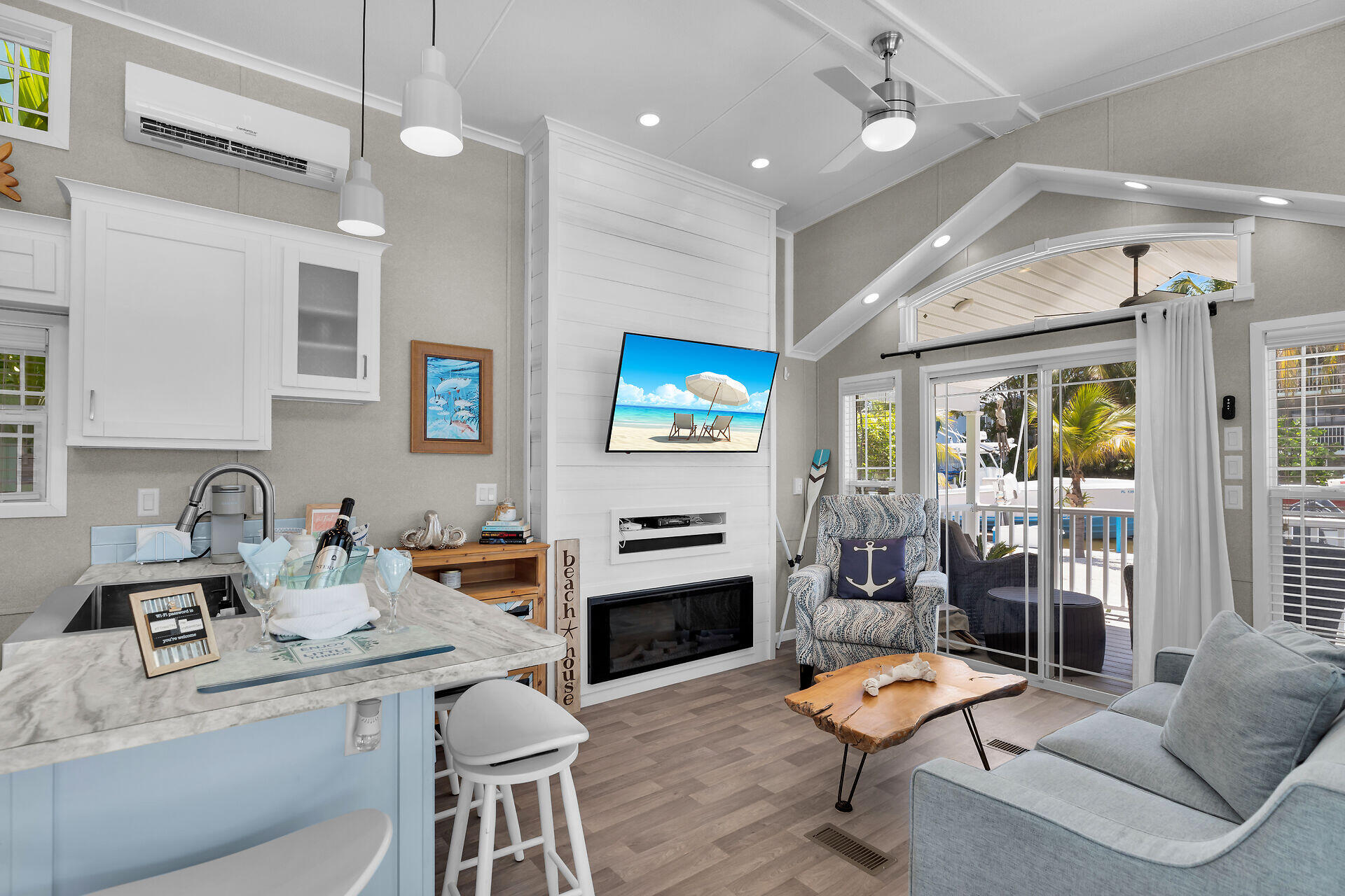 325 Calusa Street, Unit 250 Key Largo, FL 33037 - Photo 44 of 63 a living room with furniture a flat screen tv and a fireplace