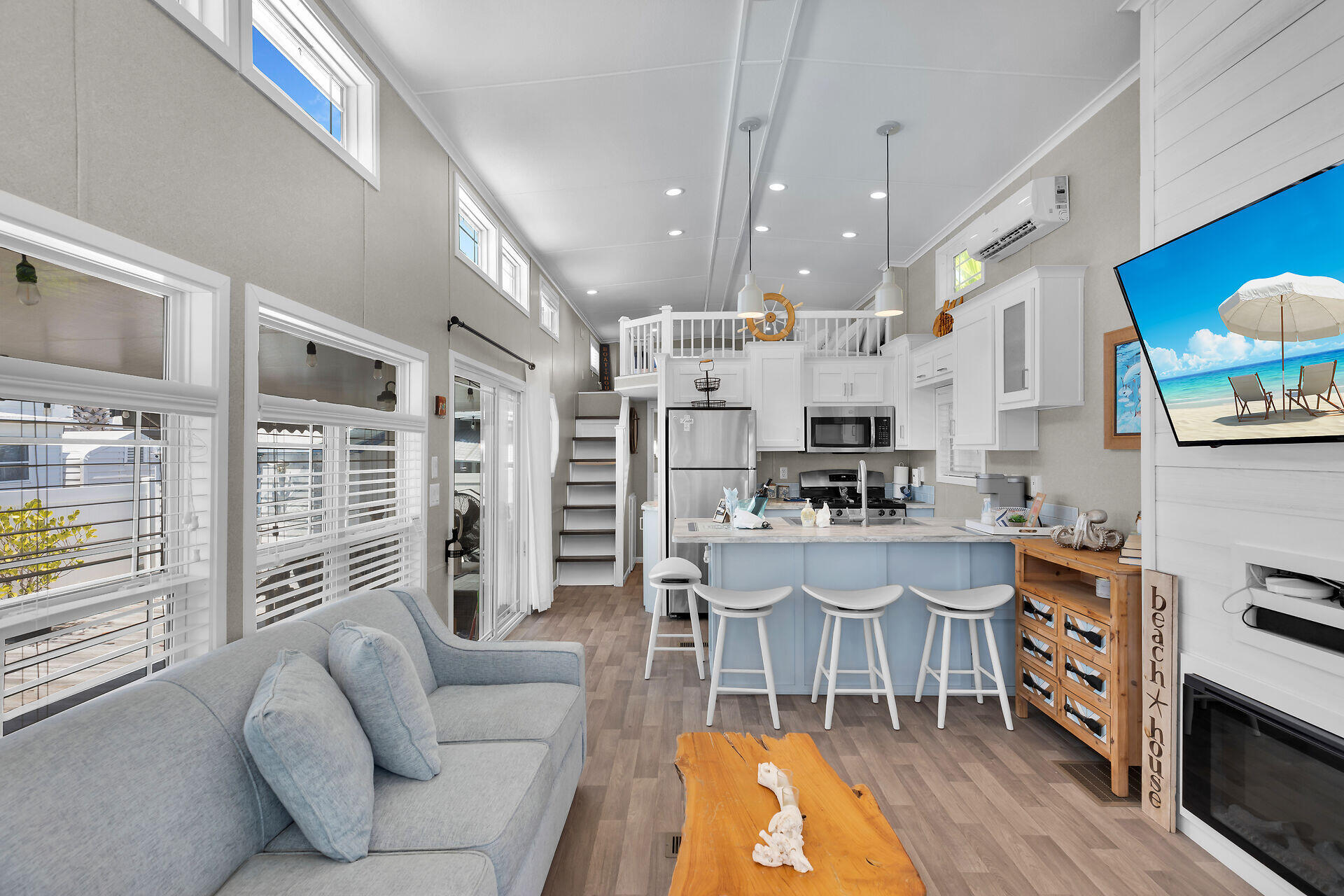 325 Calusa Street, Unit 250 Key Largo, FL 33037 - Photo 48 of 63 a living room with furniture a flat screen tv and a large window