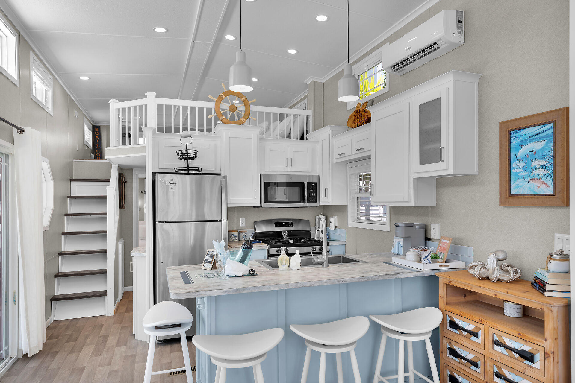 325 Calusa Street, Unit 250 Key Largo, FL 33037 - Photo 51 of 63 a kitchen with stainless steel appliances kitchen island granite countertop a dining table and chairs