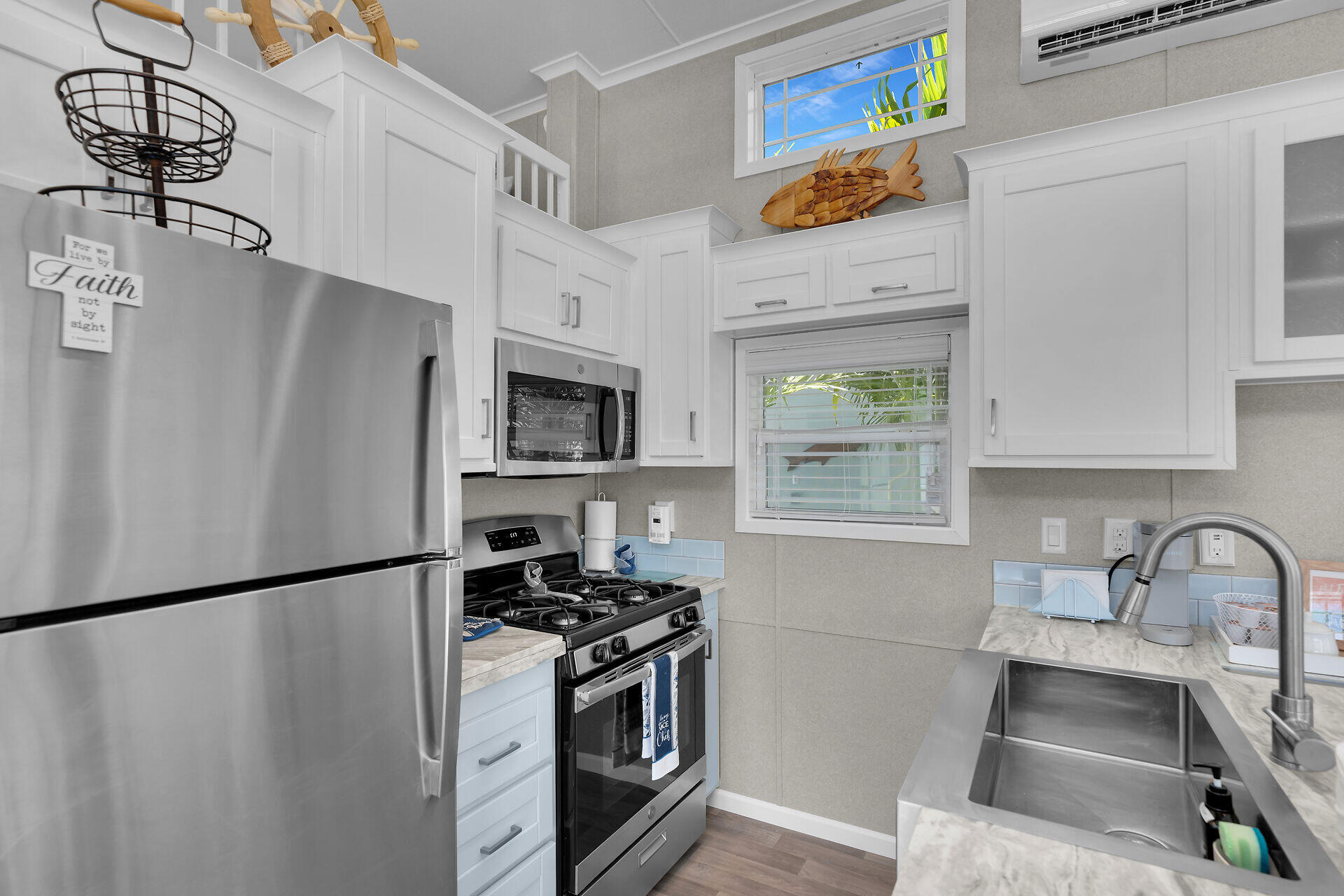 325 Calusa Street, Unit 250 Key Largo, FL 33037 - Photo 52 of 63 a kitchen with stainless steel appliances granite countertop a refrigerator a stove a sink and a microwave