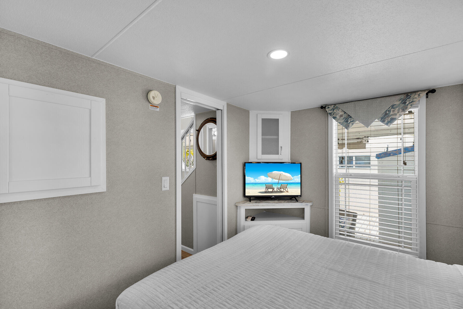 325 Calusa Street, Unit 250 Key Largo, FL 33037 - Photo 56 of 63 a bedroom with a bed and a flat screen tv