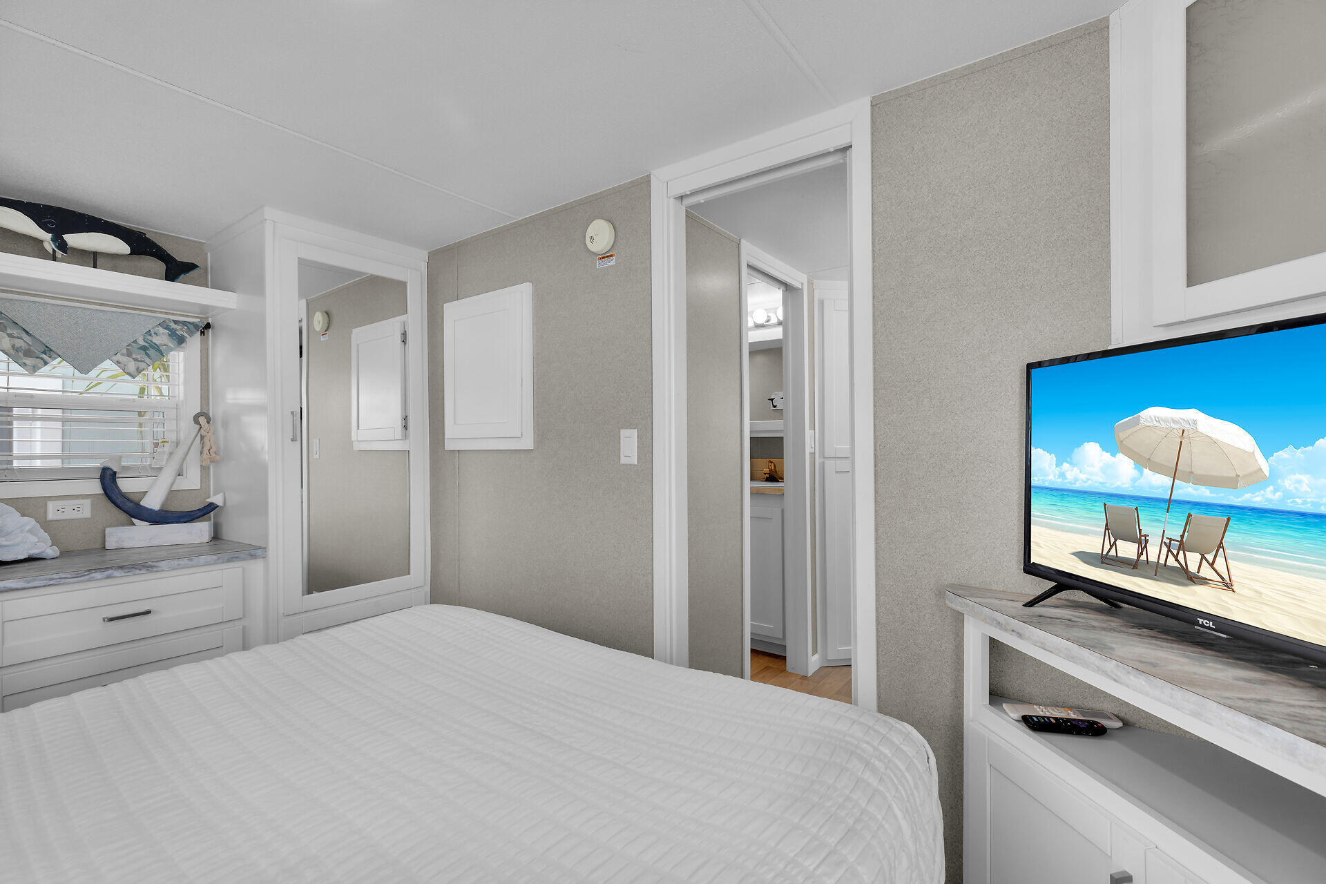 325 Calusa Street, Unit 250 Key Largo, FL 33037 - Photo 57 of 63 a bedroom with a bed and a lamp on dresser