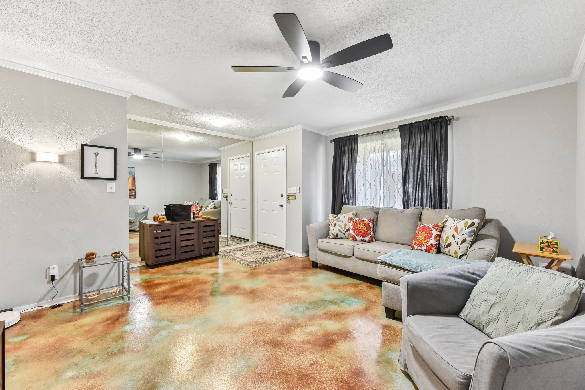 9610 Covey Ridge Lane Austin, TX 78758 - Photo 6 of 22 Living space featuring unique multi-toned flooring, a ceiling fan with integrated lighting, and white trim