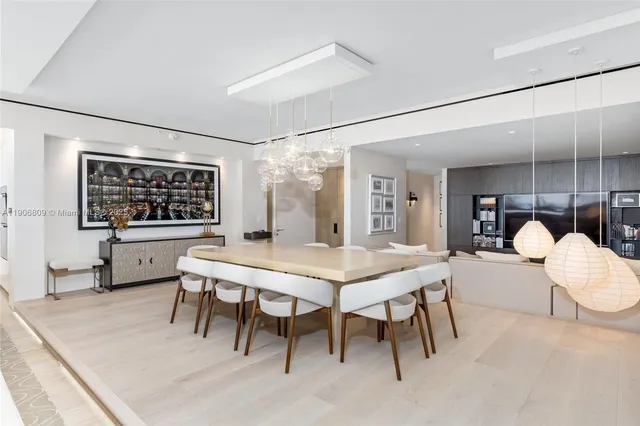 a dining hall with granite countertop a stove a sink and white cabinets