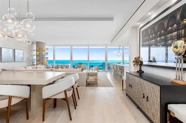 a view of hallway with livingroom and chandelier