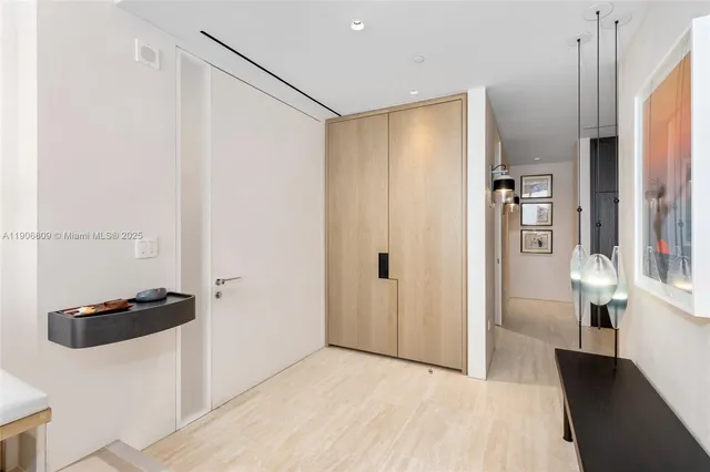 a large white bed sitting in a room next to a window