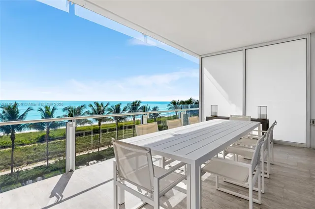 a view of building with yard and ocean view