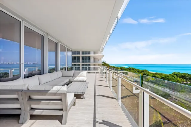a dining room with furniture a rug and a large window