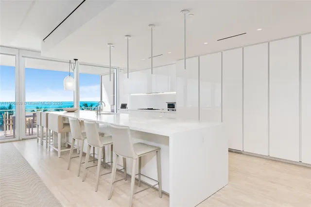 a kitchen with a table chairs stove and white cabinets