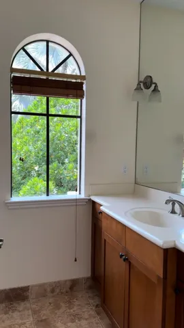 an empty room with fan and windows