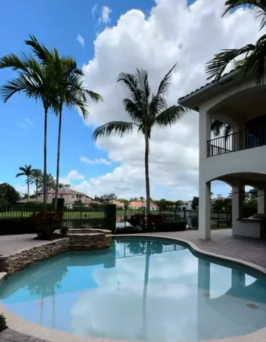 a view of swimming pool with a table and chairs