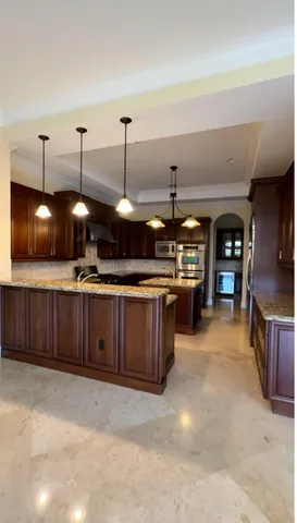 a kitchen with stainless steel appliances granite countertop a sink and a stove