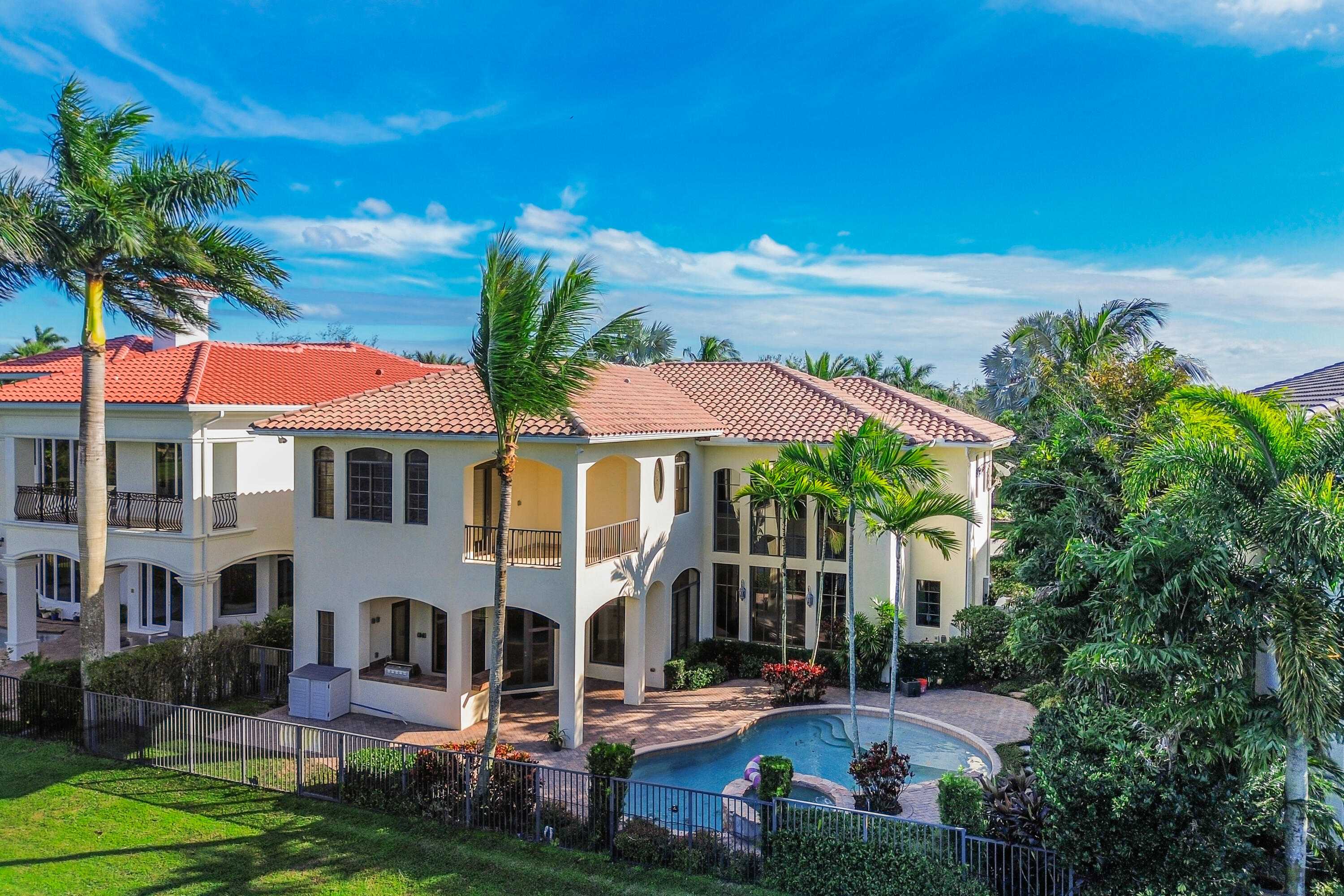 9407 Bridgebrook Drive Boca Raton, FL 33496 - Photo 71 of 89 a view of a white house with a big yard and potted plants