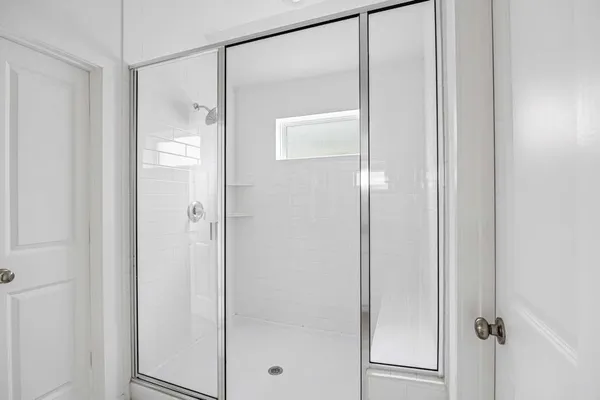 a bathroom with a glass shower door