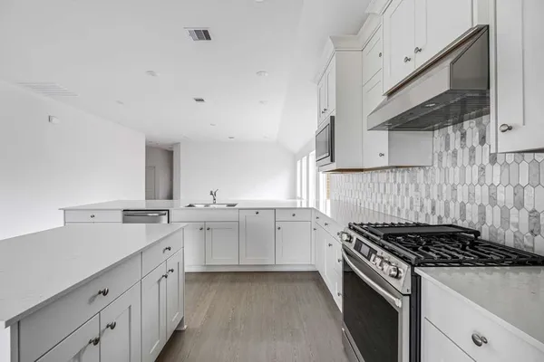 a kitchen with a sink stove top oven and cabinets