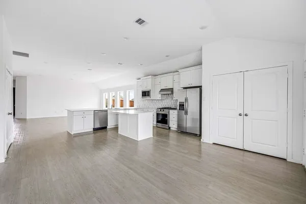 a view of a kitchen with wooden floor