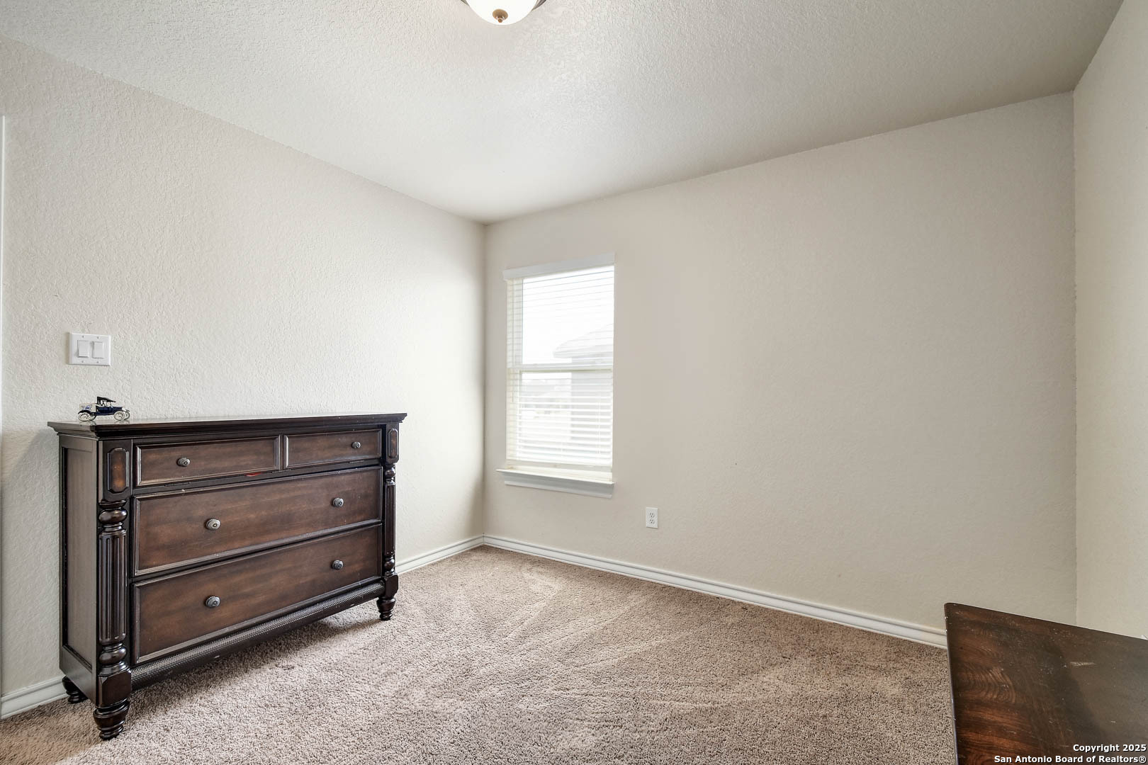 7327 Lunar Eclipse Converse, TX 78109 - Photo 22 of 24 a room with a dresser and a window