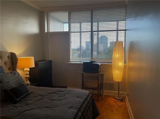 a bedroom with a bed and a window