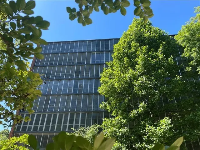 a view of a backyard with table and chairs under an umbrella