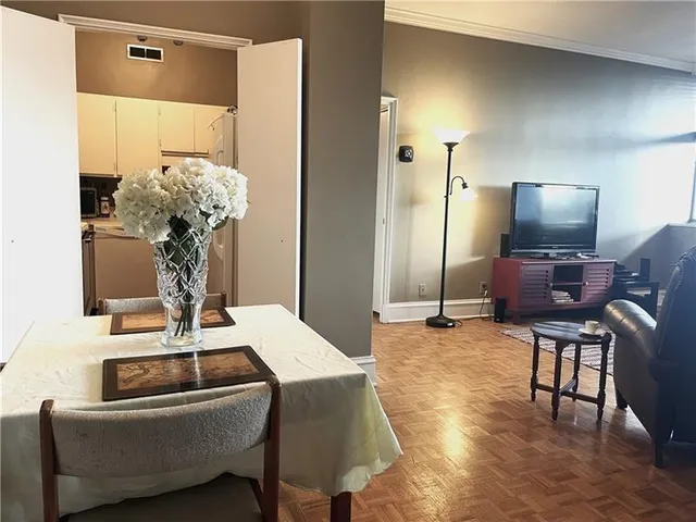 a dining room with furniture and wooden floor