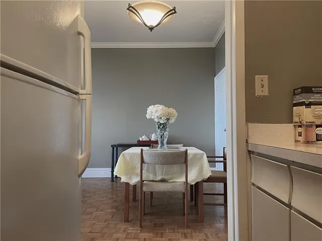 a dining room with furniture and wooden floor