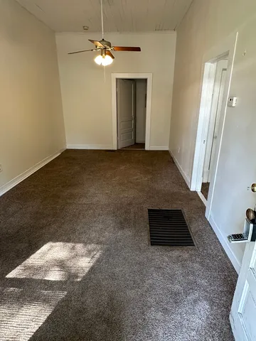 en empty room with wooden floor and window