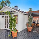 a front view of house with deck and seating space