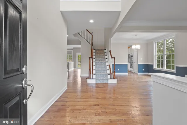 a view of an entryway with wooden floor