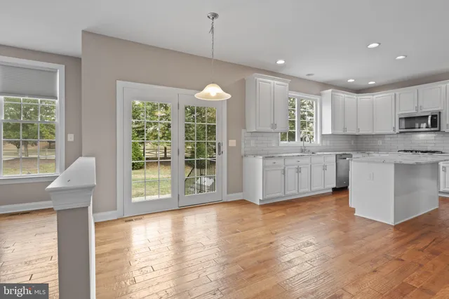 a view of kitchen with microwave and wooden floor
