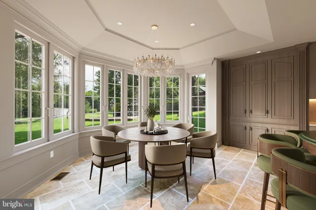 a dining room with furniture and large windows