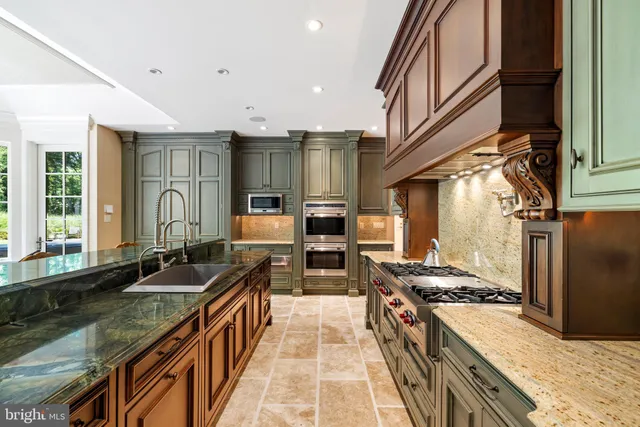a kitchen with granite countertop a stove and a sink