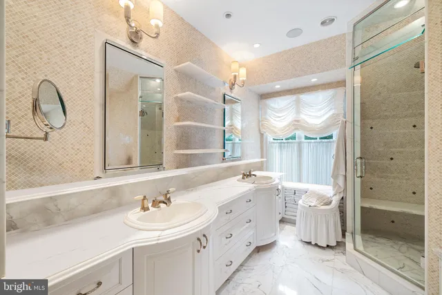 a bathroom with a double vanity sink mirror and shower