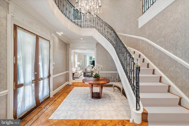 a work room with wooden floor windows and entryway
