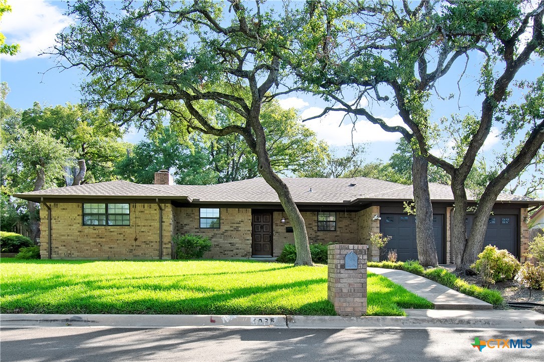 a front view of a house with garden and porch